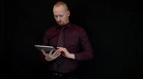 Businessman on black background typing on the tablet Stock Footage 60062655
