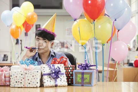 Businessman Blowing a Party Horn Stock Photos