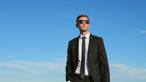 Businessman On Blue Sky Background Stock Footage 77434646