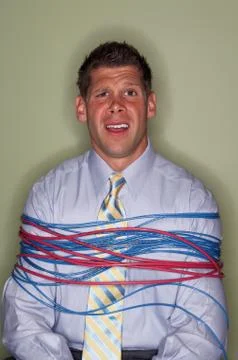 Businessman bound with cables Stock Photos