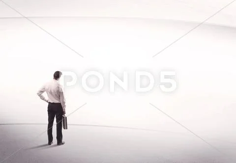Businessman with briefcase standing still Stock Photos