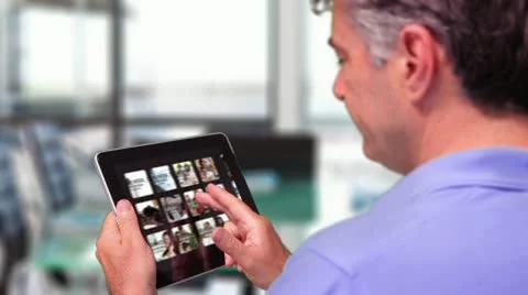 Businessman Browsing iPad Gallery After Effects stock