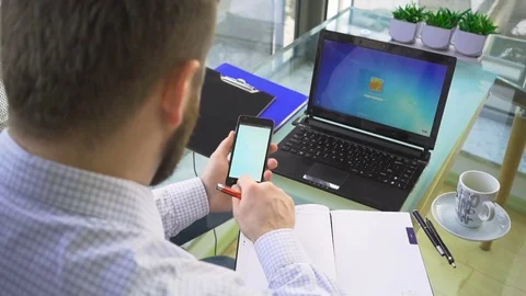 Businessman browsing smartphone, make notes, close behind shot, office Stock Footage 73166432