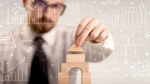 Businessman building a tower Stock Photos