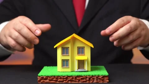 A businessman builds a house on a plot of land. Design and engineering of a Video stock 342259389