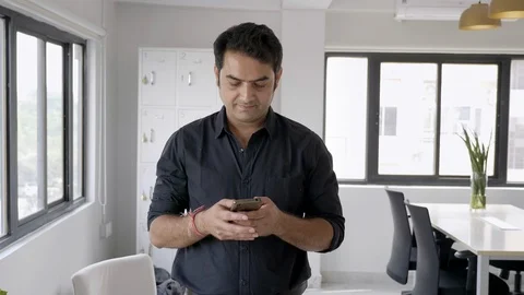 A businessman is busy typing a text message on a cellphone Stock Footage 124893829