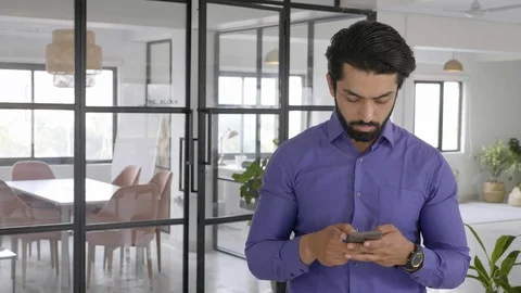 A businessman is busy typing a text message on a cellphone  Stock Footage 124896301