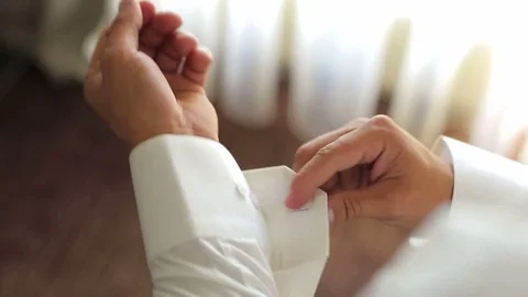 Businessman buttoning cuff links on his shirt. Stock Footage 80361670