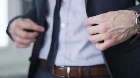 Businessman buttoning his jacket and checking hour on his watch Stock Footage 68398291