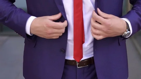 Businessman buttoning jacket, close-up. 動画素材 80974881
