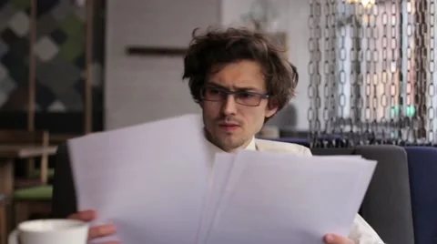 Businessman in a cafe looking documents Stock Footage 61516228