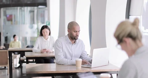 Businessman in a café using a laptop Stock Footage 104644357