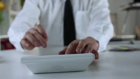 Businessman calculating accounts using calculator Stock Footage 265146302