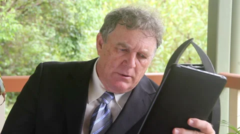 Businessman Calculating On Tablet Stock Footage 37792197