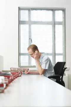 Businessman On Call Noting On Notepad Stock Photos