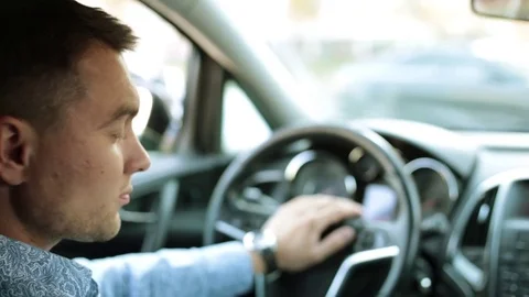 Businessman in car looking at clock. Stock Footage