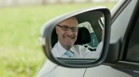 Businessman in car smiling at camera Stock Footage 2616367