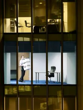 Businessman Carrying Stack Of Boxes In Office Stock Photos