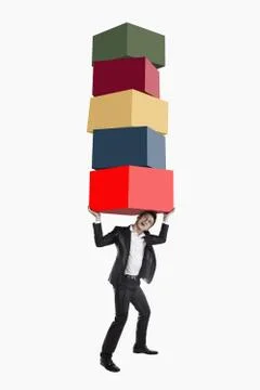 Businessman carrying a stack of cubes 스톡 사진