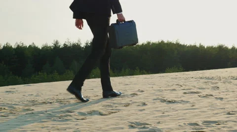 Businessman with case goes away, the frame can be seen only the legs. Goes on Stock Footage 65971097