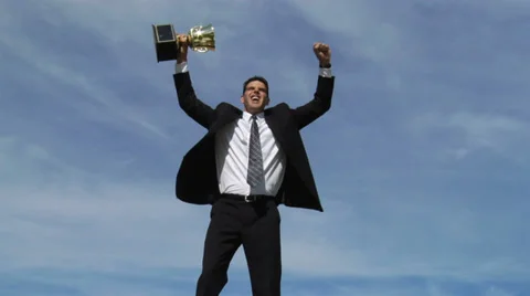 Businessman celebrating with trophy Stock Footage 32708083