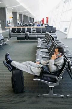 Businessman on cell phone at airport Stock Photos