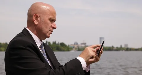 Businessman in Central Park Text Using Cellphone Wireless Network Communication Stock-Footage 102252262