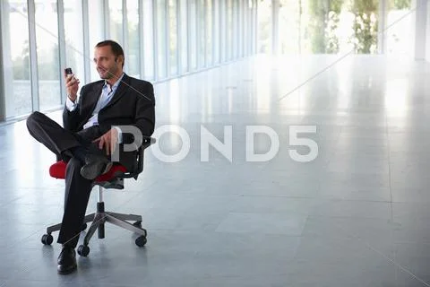 Businessman On A Chair, In Empty Office