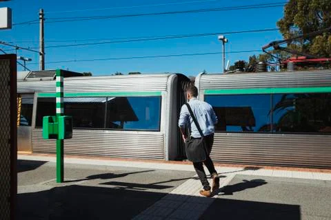 Businessman Chasing the Train Stock Photos