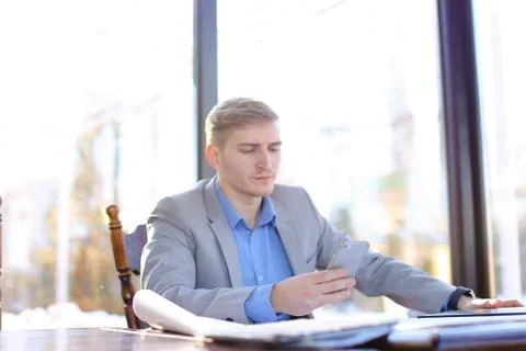 Businessman checking architecture project at cafe table. Stock Photos