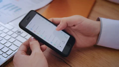 Businessman checking banking app on smartphone Stockbeeldmateriaal 339607942
