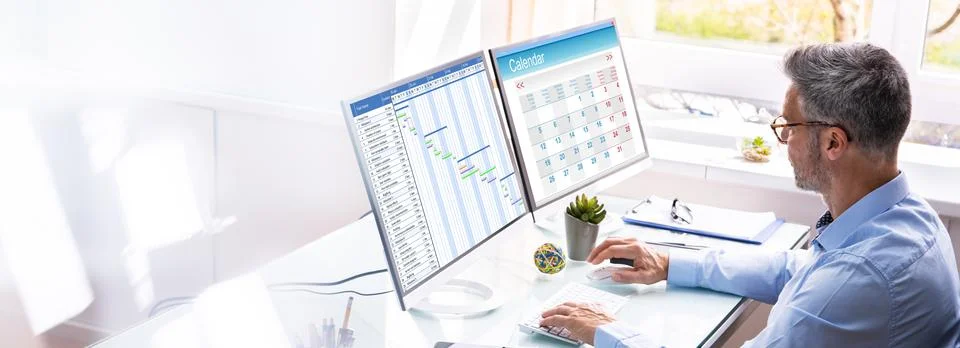Businessman Checking Calendar On Computer Screen 스톡 사진