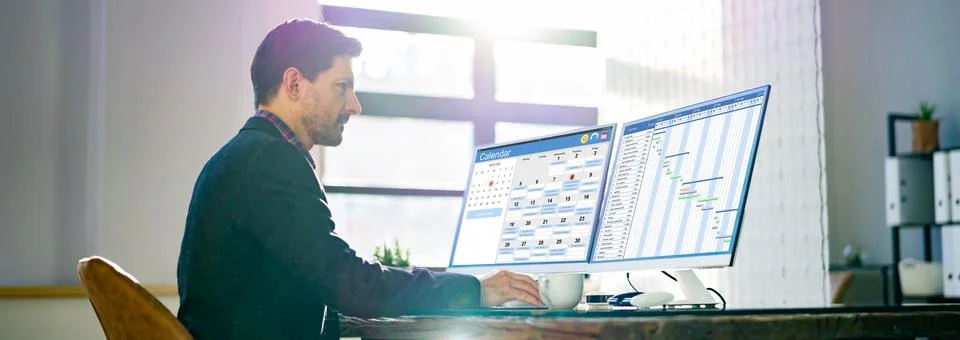 Businessman Checking Calendar On Computer Screen 스톡 사진