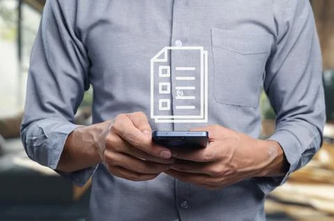 Businessman Checking Document on Smartphone in Modern Office Space Stockfoto's