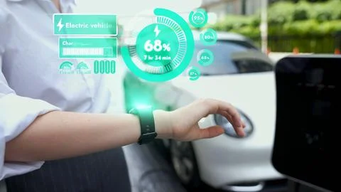 Businessman checking EV car battery status in hologram from smartwactch. Peruse Foto stock