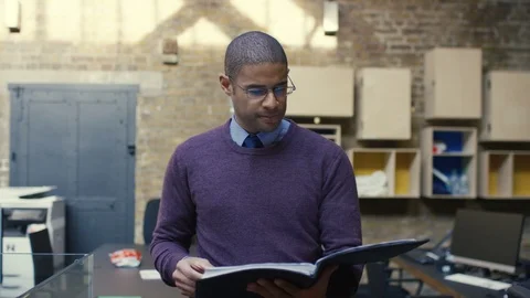 Businessman checking a file while walking around office Stock Footage 107891732