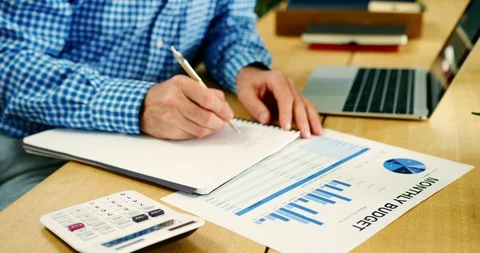 Businessman Checking Financial Data And Writing Report Stock Footage 100044197