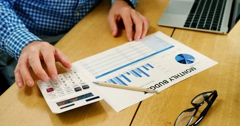 Businessman Checking Financial Data While Using Calculator Stock Footage 100044167