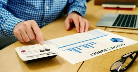 Businessman Checking Financial Data While Using Calculator Stock Footage 100044177