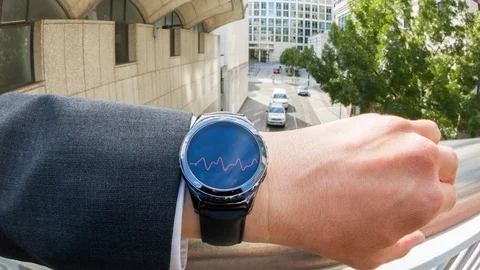 Businessman checking his pulse on a smartwatch Video stock 104050291