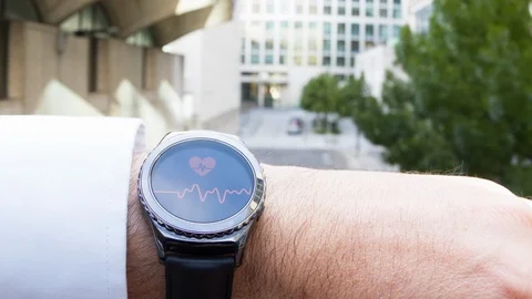 Businessman checking his pulse on a smartwatch Stock-Footage 104050845