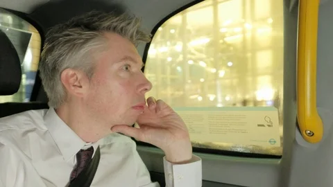 Businessman checking his watch in the back of a taxi cab Stock Footage 85617259