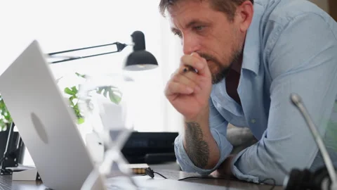 Businessman checking information on a laptop while working at his desk. Onl.. Stock Footage 341750796