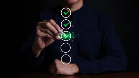 Businessman checking mark on checklist with a red checkmark. Stock Photos