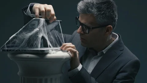 Businessman checking an old laptop covered with dust and cobwebs Stock Footage 90640792