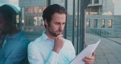 Businessman checking papers and doing serious look to the camera. Business Stock Footage 164840112