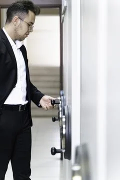 Businessman Checking Register Document at Metal filing cabinet Foto stock