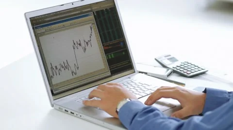 Businessman checking stock market at his laptop computer Stock Footage