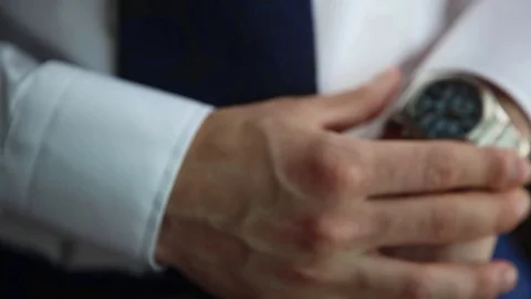 Businessman checking the time on his watch Stock Footage 71021940