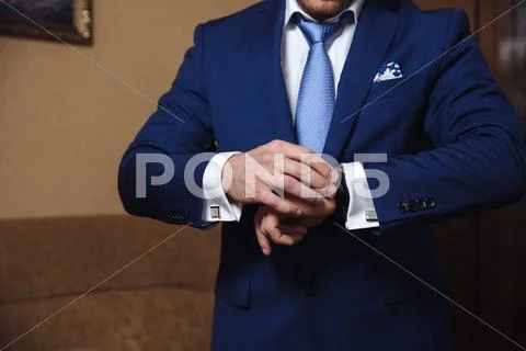 Businessman checking time on his wristwatch. men's hand with a watch Stock Photos